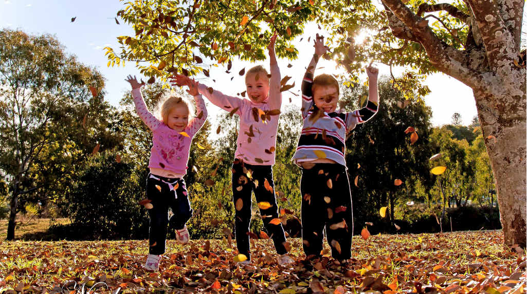 Emmaline, Kaitlyn and Alexander Newley make their own fun in the autumn leaves.